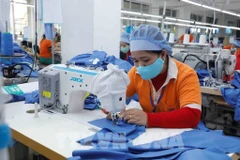 Une usine de production dé produits d'habillement aux exportations. Photo : VNA