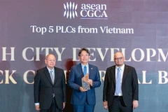 Le président de HDBank, Kim Byoungho (au centre), reçoit le prix des mains des organisateurs. — Photo : VNA
