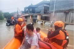 Rescuers from Indonesia's National Search and Rescue Agency evacuate residents from a flooded home in Denpasar, Bali. (Photo: AP)