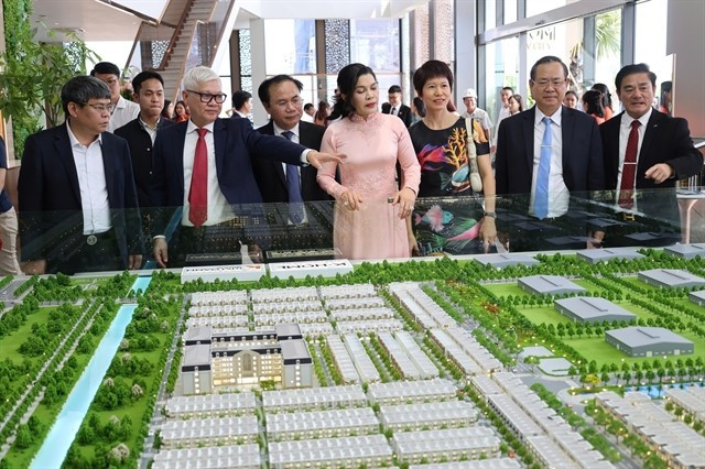Des responsables du ministère de la Construction et de la province de Binh Duong (aujourd’hui Hô Chi Minh-Ville) examinent le modèle d’un projet de logements sociaux. Photo : VNA projet-de-logement-social-binh-duong.jpg
