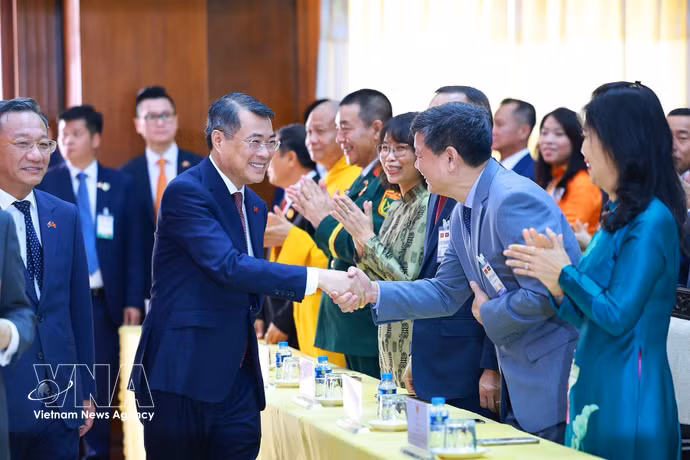 Le Premier ministre Lê Minh Hung rencontre des représentants de la communauté vietnamienne au Laos. Photo: VNA