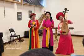 Des artistes interprètent la chanson "Trong Com" (Tambour de riz), traduite en français. Photo : VNA