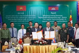 Le vice-président du Comité populaire provincial, Le Trung Ho (à gauche) et Khiev Rithiphorn, vice-gouverneur de la province de Kampot, signent un accord sur la mise en œuvre de l'accord commercial frontalier Vietnam-Cambodge. Photo : VNA 