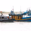 Des gardes-frontières inspectent des bateaux de pêche au port de pêche de La Gi. Photo: VNA