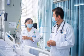Deux spécialistes de l'hôpital Cho Ray examinent les options thérapeutiques pour la victime. Photo : VNA