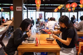 Des étudiants de l’Université des langues étrangères Kanda dégustent le pho vietnamien. Photo: VNA