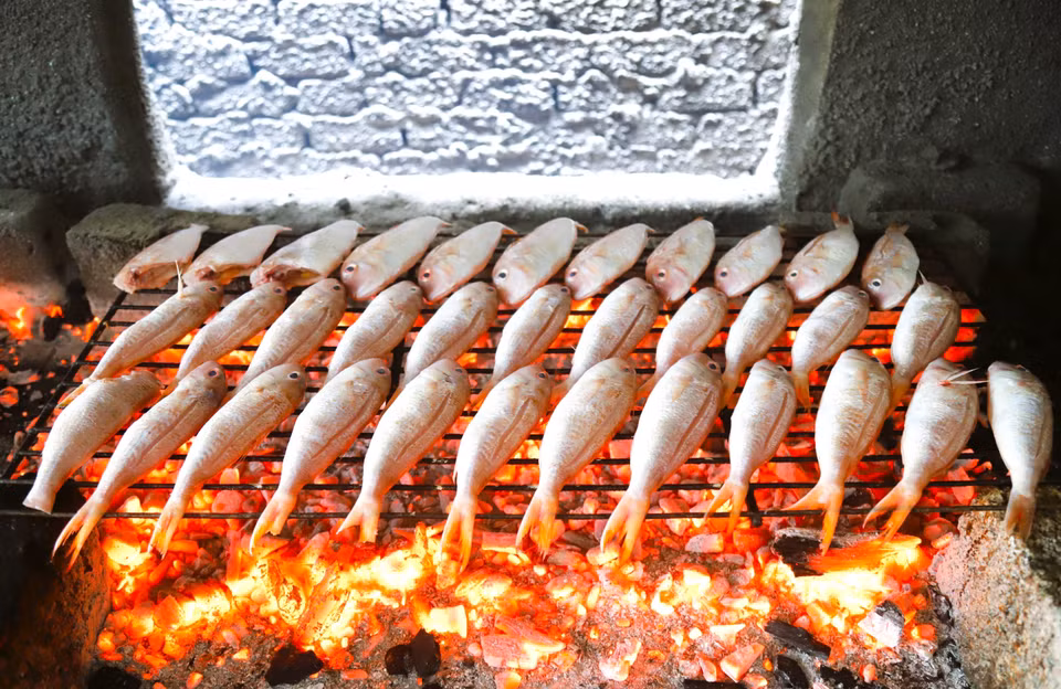 Après avoir été nettoyé et séché naturellement, les maquereaux sont disposés sur des grilles métalliques de 30 cm de large sur 75 cm de long pour être grillé. Photo : VNA