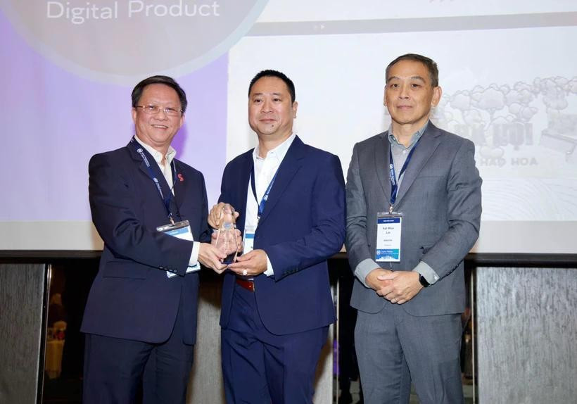 Le journaliste Tran Ngoc Long (au milieu), représentant le journal électronique VietnamPlus, a reçu le prix en Malaisie. (Photo : PV/Vietnam+)