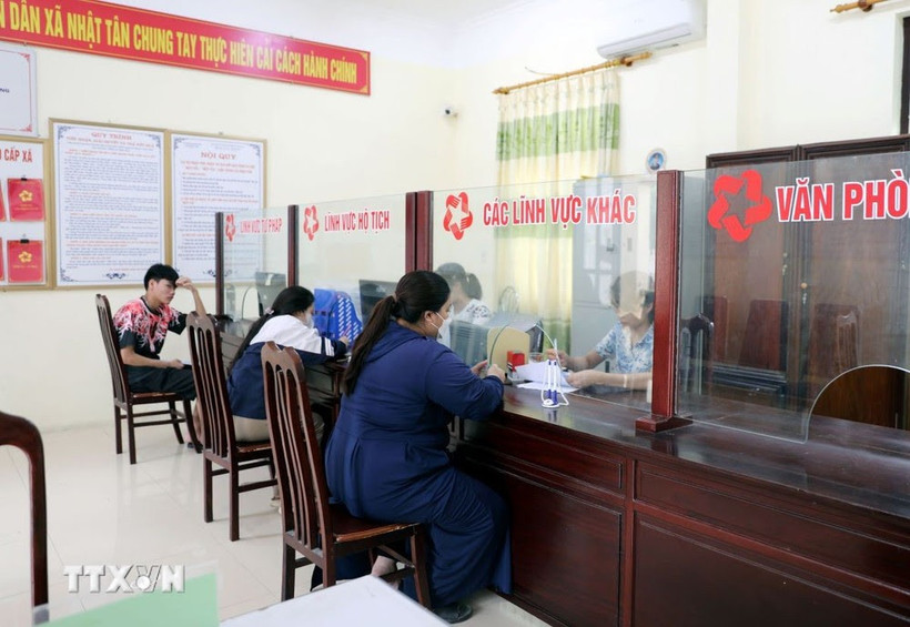 Des gens effectuent des démarches administratives au service "guichet unique" de la commune de Nhat Tan, district de Kim Bang, province de Ha Nam. Photo : VNA