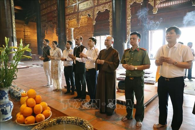 Des délégués offrent des baguettes d'encens à la pagode Tam Chuc. Photo : VNA