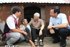 Le secrétaire général Nguyên Phu Trong (2e à partir de la droite) rend visite à la famille de l’invalide de guerre Dinh Phi, une famille bénéficiaire bénéficiaires de politiques sociales, dans le village de Tung Ke 2, commune d’Ayun, district de Chu Sê, province de Gia Lai, le 12 avril 2017. Photo : VNA