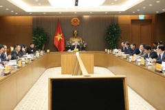 Réunion sur le plan d'action pour mettre en œuvre la conclusion du Bureau politique sur la construction des places financières régionale et internationale au Vietnam. Photo: VNA