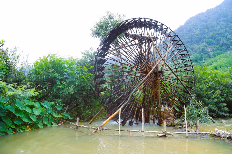 Afin de limiter l’accumulation de débris, de branches et de feuilles de forêt qui pourraient se coincer dans les pales et les tubes d’eau — ce qui alourdirait le fonctionnement de la roue et de l'axe —, les habitants installent une barrière sur le ruisseau en amont de la noria. Photo : VNA