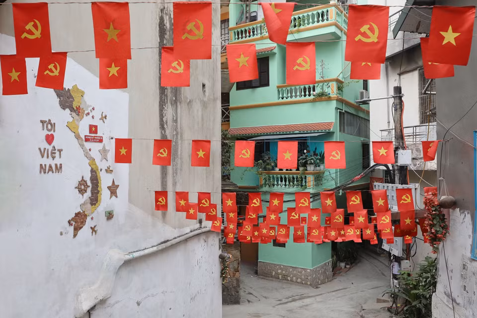 Drapeau rouge vif avec étoile jaune dans une petite ruelle de la rue Yên Phu, arrondissement de Tây Hô. Photo: VNA