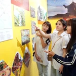 Des jeunes contemplent des oeuvres exposées lors de l'exposition thématique. Photo: VNA