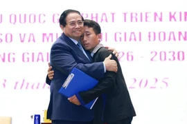 Le Premier ministre Pham Minh Chinh (gauche) et Mua A Thi, chef du village Hang Pu Xi, commune de Xa Dung, province de Diên Biên, pour son courage exemplaire lors d’une crue soudaine. Photo : VNA