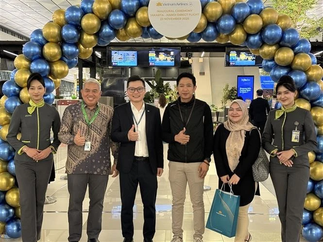 Un représentant de Vietnam Airlines en Indonésie (troisième à partir de la gauche) avec des passagers à l'aéroport international Soekarno-Hatta, en Indonésie. Photo : VNA