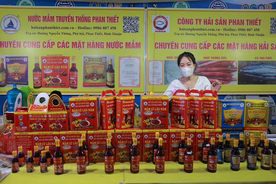 Des bouteilles de «nuoc mam» de Phan Thiet sont présentées lors de la Semaine. Comme le riz, le «nuoc mam » est un condiment de base de presque tous les plats au Vietnam. «Pour les Vietnamiens, un repas sans nuoc mam est considéré comme incomplet», a écrit le Professeur Trân Ngoc Thêm dans son livre Les fondements de la culture vietnamienne. Un bol de nuoc mam (sauce de poisson) est toujours placé au centre de la table afin que chacun puisse l’atteindre. Certains peuvent ne pas manger de légumes, d’autres de viande, mais tout le monde consomme du riz et du «nuoc mam». On dit que le «nuoc mam» permet de distinguer la nourriture vietnamienne de celle de ses voisins.