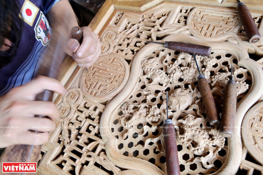Les professionnels des villages d'artisanat traditionnels du bois du Vietnam, avec leur talent et leur créativité, sculptent des motifs délicats. 