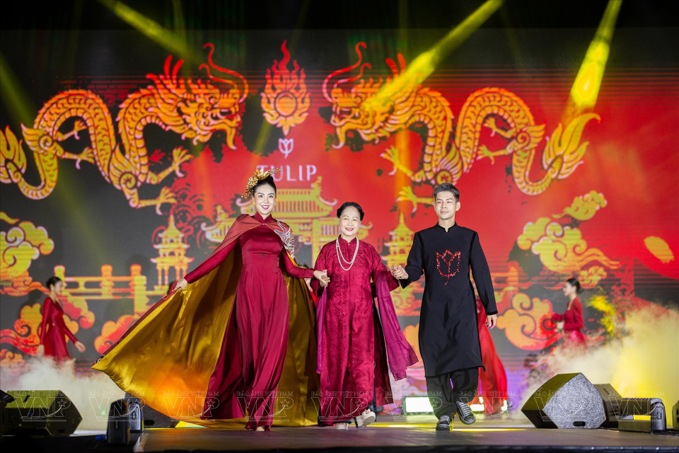 Le designer Dung Nguyen, accompagné de l'Artiste du peuple Thu Quynh et de la présentatrice Mai Ngoc, présente ses "ao dai" (tunique traditionnelle vietnamienne). 