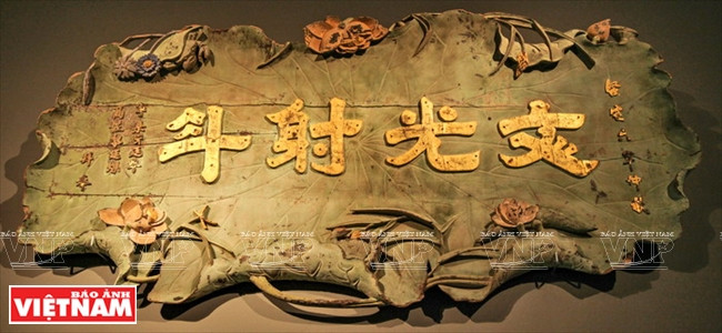 Le panneau « Van quang xa dau » en forme de feuilles de lotus décoré de fleurs et bourgeons.