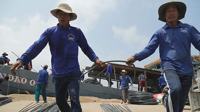 Un cargos spécialisé transporte des matériaux pour les travaux de construction sur l'île.