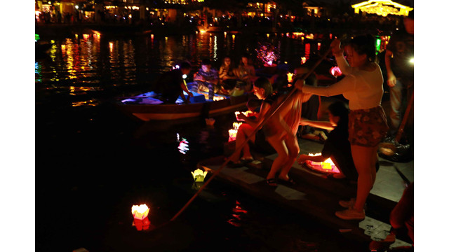 Une famille étrangère a acheté 4 lanternes et a pris ensemble une photo souvenir et l’a publié sur Facebook. Puis ils ont lâché ensemble les lanternes sur la rivière Hoài.