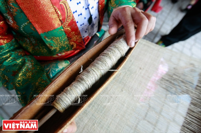 Les fibres de lin sont entrelacées autour d’une navette de tissage. 