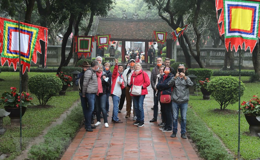 Des touristes étrangers visitent le Temple de la Littérature. Photo: VietnamPlus 