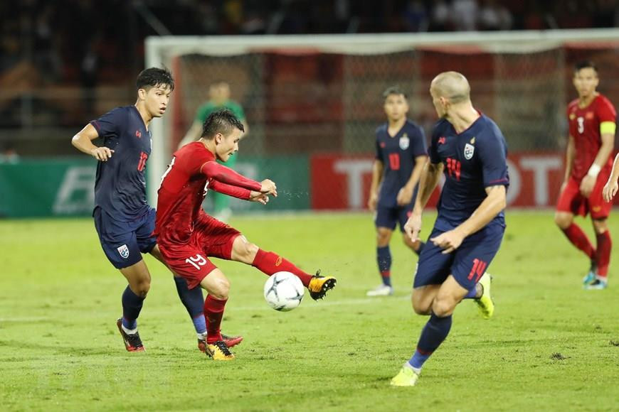 Le milieu de terrain Nguyên Quang Hai (maillot rouge). Photo: VNA