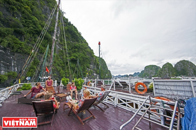 Touristes admirant la beauté de la mer sur le pont du bateau.