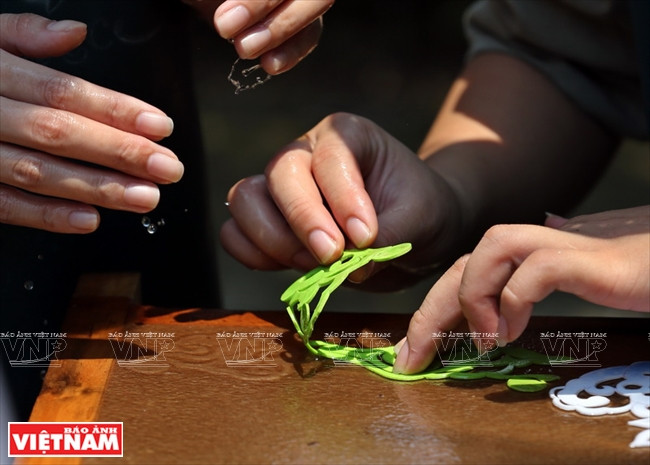 Sous la pression de l’eau, la poudre de papier se dépose en formant des motifs décoratifs. 