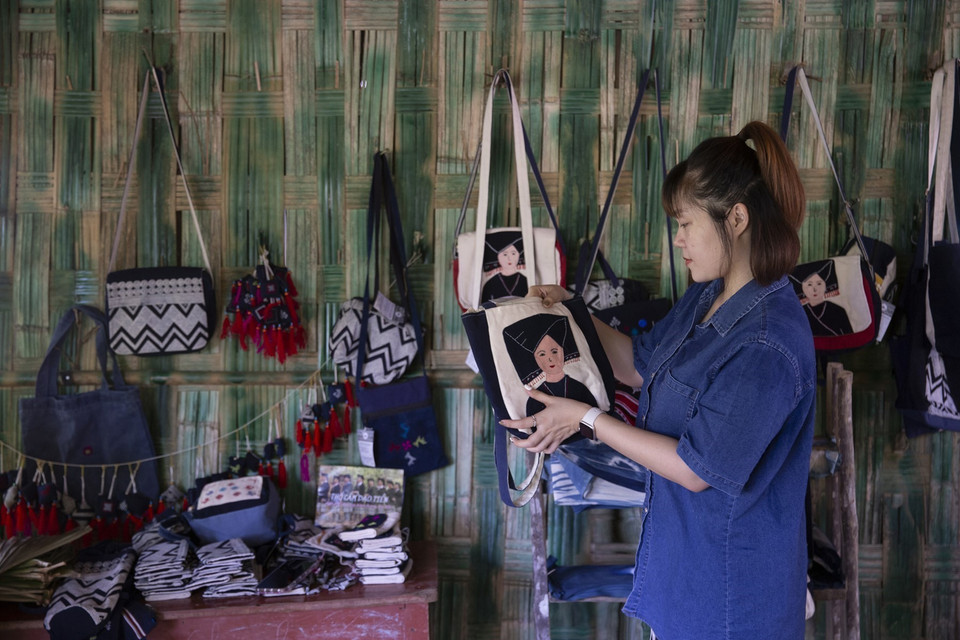 Une touriste achète des produits de brocatelle. 