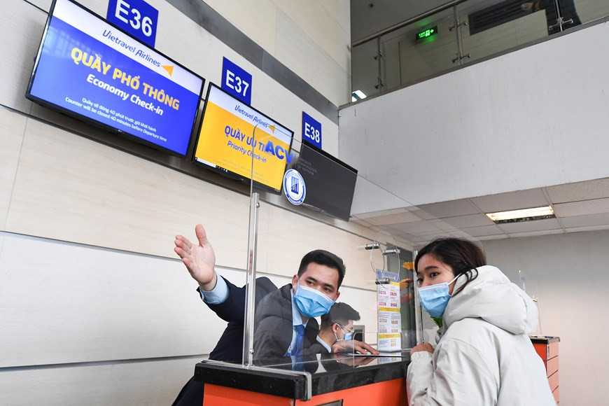 Les passagers portant des masques de protection à l’aéroport international de Nôi Bai (Hanoï) pour la lutte contre l’épidémie de Covid-19. Photo : Vietravel
