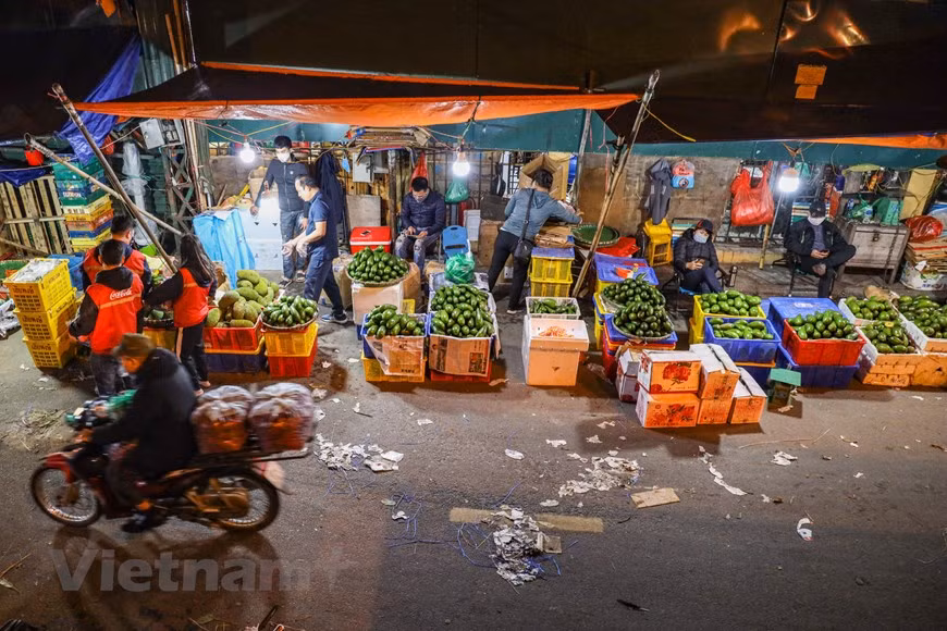 Comme les fruits sont l'un des produits essentiels, durant la période de distanciation sociale, les activités commerciales dans ce marché étaient toujours en place. Photo: VNA
