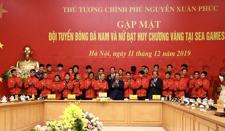 Le Premier ministre Nguyen Xuan Phuc prend une photo avec l'équipe de football masculin.