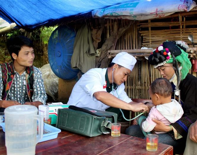 Un médecine militaire de la délégation économique nationale 365 examine un enfant dans la commune de Pa Vay Su, district de Phong Tho, province de Lai Chau.