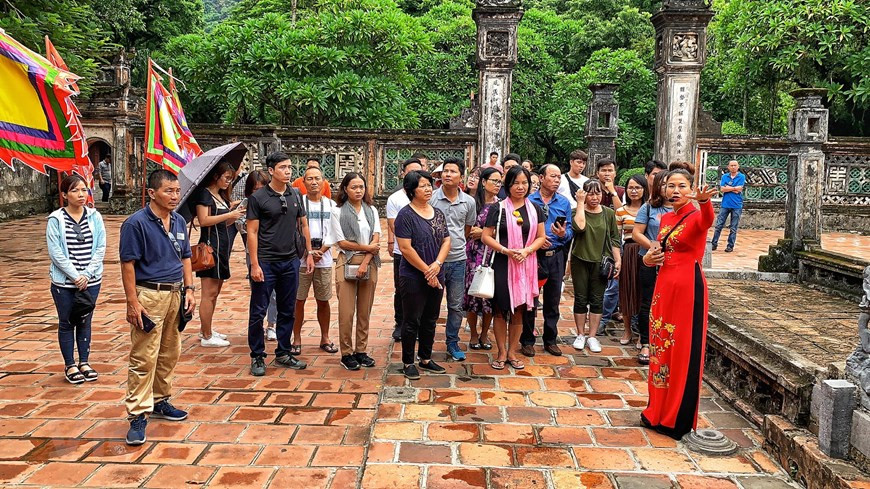 Une guide touristique présente le temple dédié au roi Dinh Tien Hoang. Photo: Vietnam +