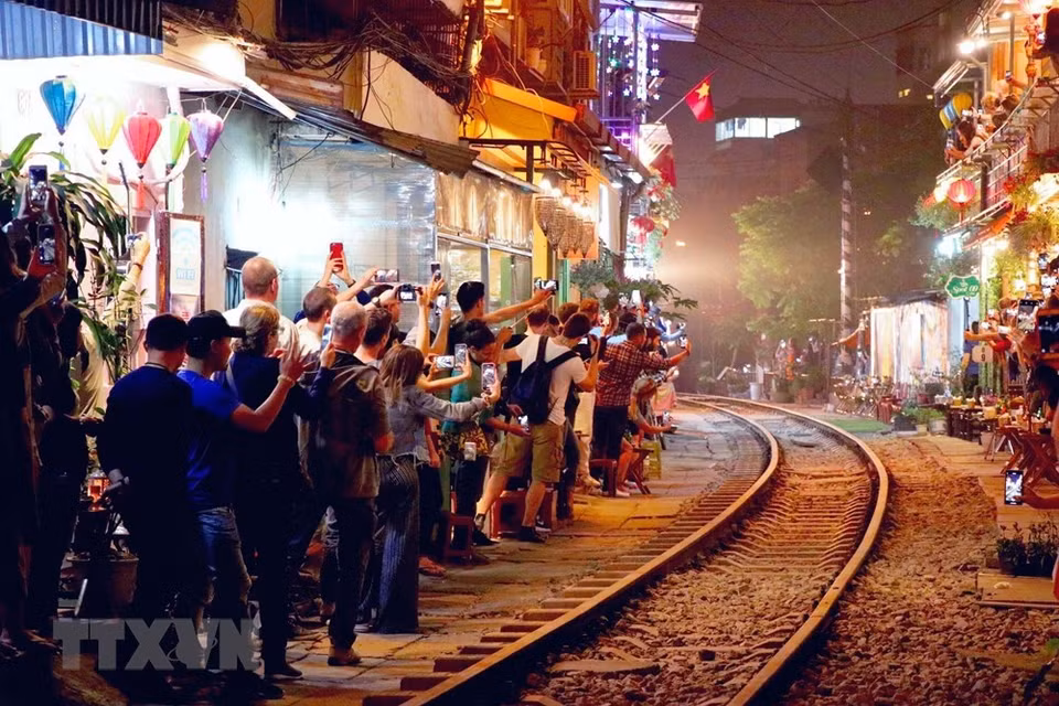 Les touristes préparent leurs appareils photo et leurs téléphones portables pour captiver les images, lors que le train est apparu. Les visiteurs ont applaudi avec joie, rendant l'atmosphère où la petite rue est devenue bruyante 
