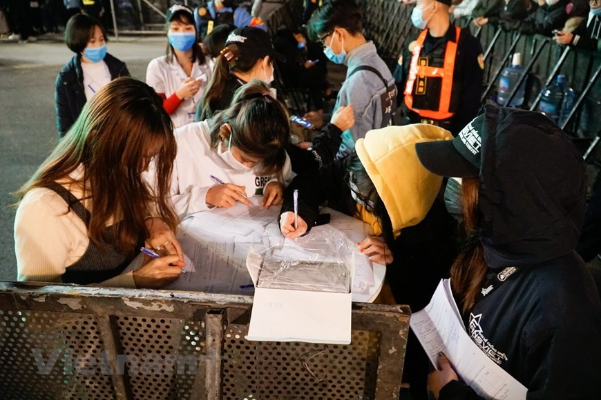 Les spectateurs du compte à rebours font la déclaration médicale avant l'entrée à l'événement. (Photo: VNA)