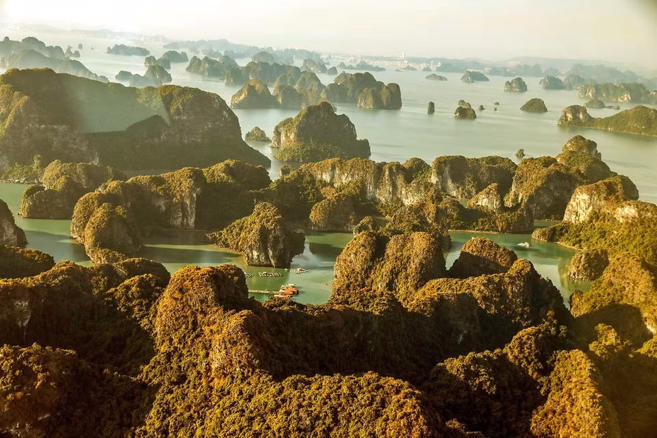 Le coucher de soleil sur la baie d'Ha Long jette une couleur dorée sur les îlots calcaires. Photo: VNA