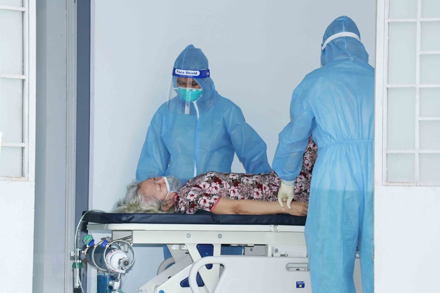 Des médecins de l'Hôpital de campagne No4 implanté dans la commune Vinh Loc B, district de Binh Chanh prennent en charge des patients du COVID-19. Photo: VNA