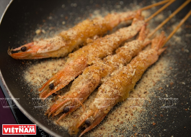 Les crevettes qui viennent d’être frites sont saupoudrées de sel de Tây Ninh. 