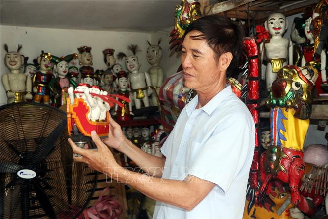 L'artisan Phan Van Manh, de la commune de Hong Quang, district de Nam Truc présente des marionnettes.
