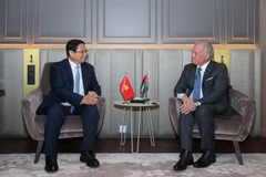 Le Premier ministre Pham Minh Chinh (gauche) et le roi de Jordanie, Abdallah II bin Al Hussein. Photo: VNA