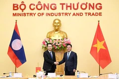 Le ministre de l'Industrie et du Commerce, Nguyen Hong Dien (droite) et son homologue lao, Malaithong Kommasith. Photo: VNA
