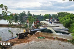 La coopérative agricole de Phu Ho, dans la ville de Hué, a mobilisé du personnel et des pompes pour drainer les eaux de crue. Photo: VNA