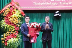 Lê Minh Hung, membre du Bureau politique, secrétaire du Comité central du Parti et chef de la Commission d'organisation du Comité central du Parti, remet la décision au nouveau secrétaire du Comité municipal du Parti de Huê, Nguyên Dinh Trung. Photo: VNA