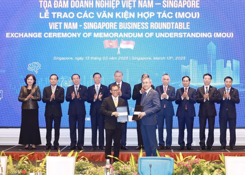 Échange du protocole d'accord de coopération entre Vietnam Airlines et Singapore Airport Terminal Services Limited (SATS). Photo: VNA