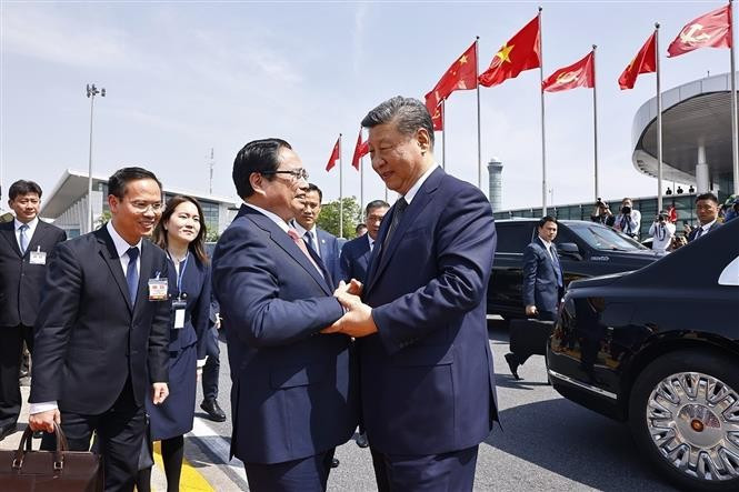 Le Premier ministre Pham Minh Chinh (gauche) dit au revoir le leader chinois Xi Jinping à l'aéroport international de Nôi Bài. Photo : VNA